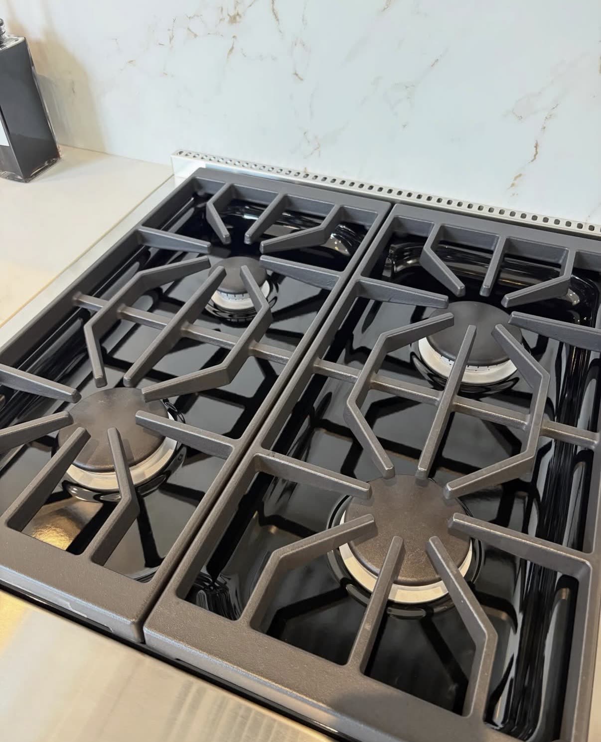 Polished gas stovetop and grates after an Iconiq deep clean