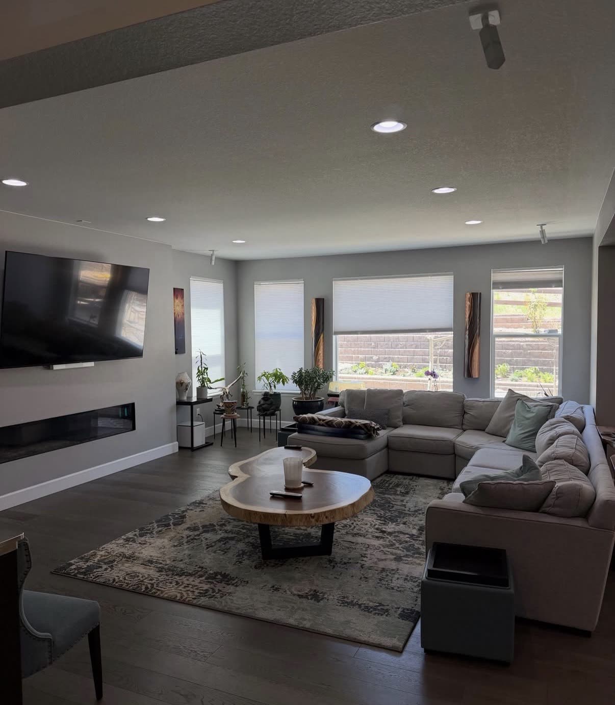 Modern Tampa living room with sectional and mounted TV after an Iconiq clean