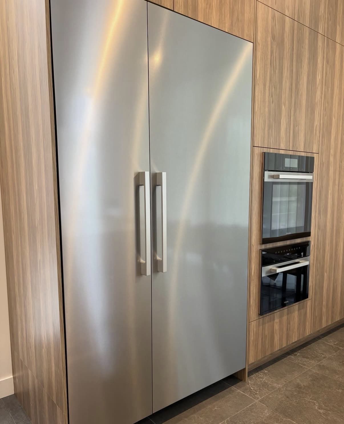 Streak-free stainless steel fridge in a modern Tampa kitchen